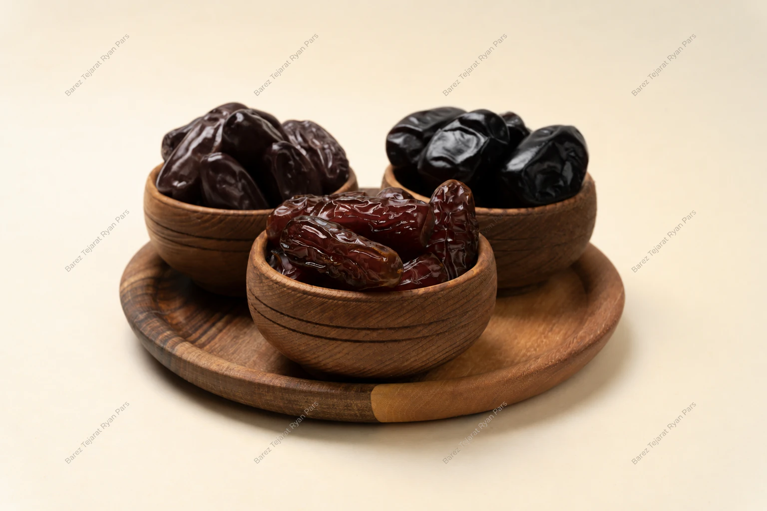 Different Iranian date varieties in three wooden bowls