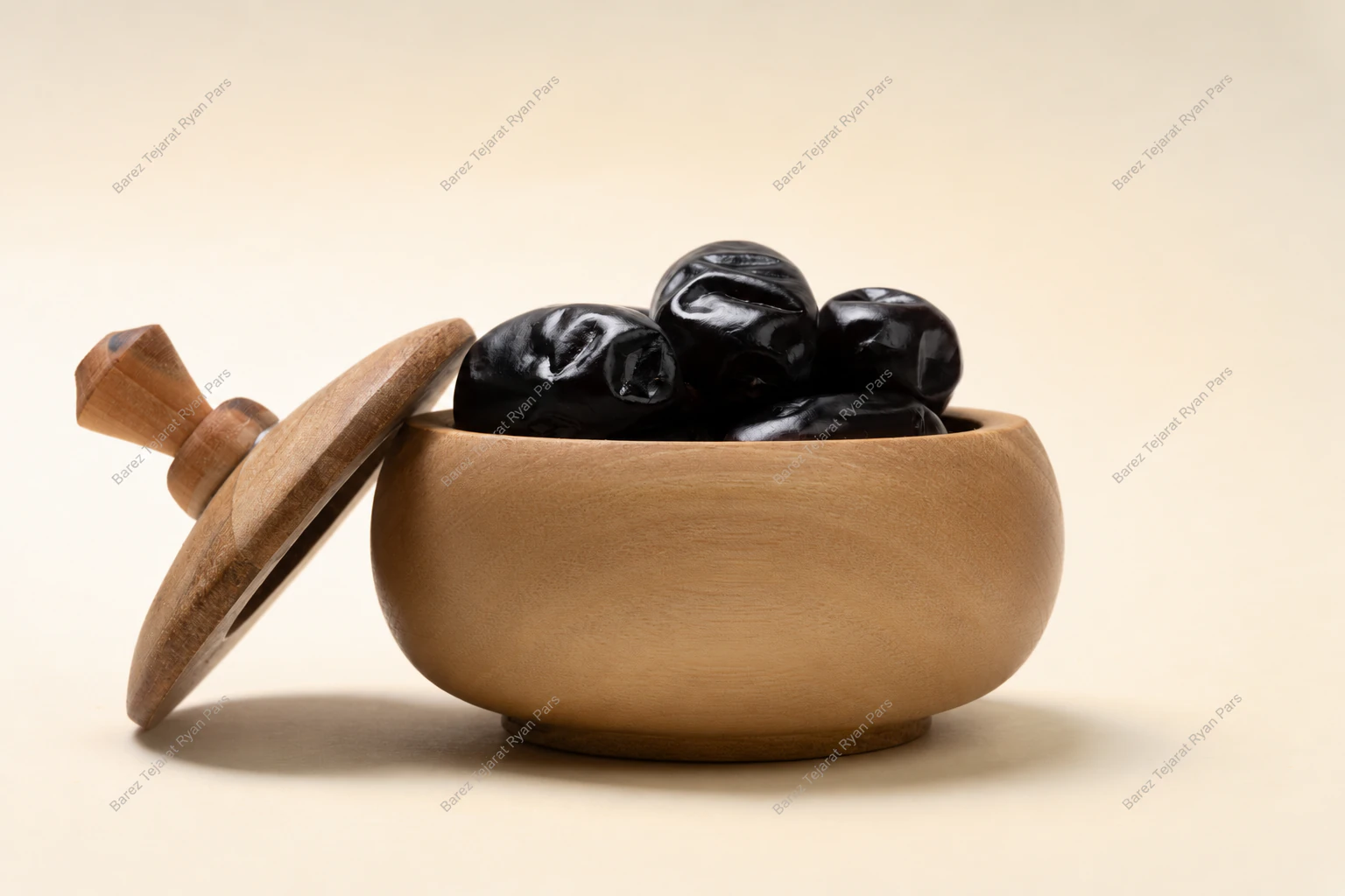 Mazafati dates in a wooden bowl with a lid